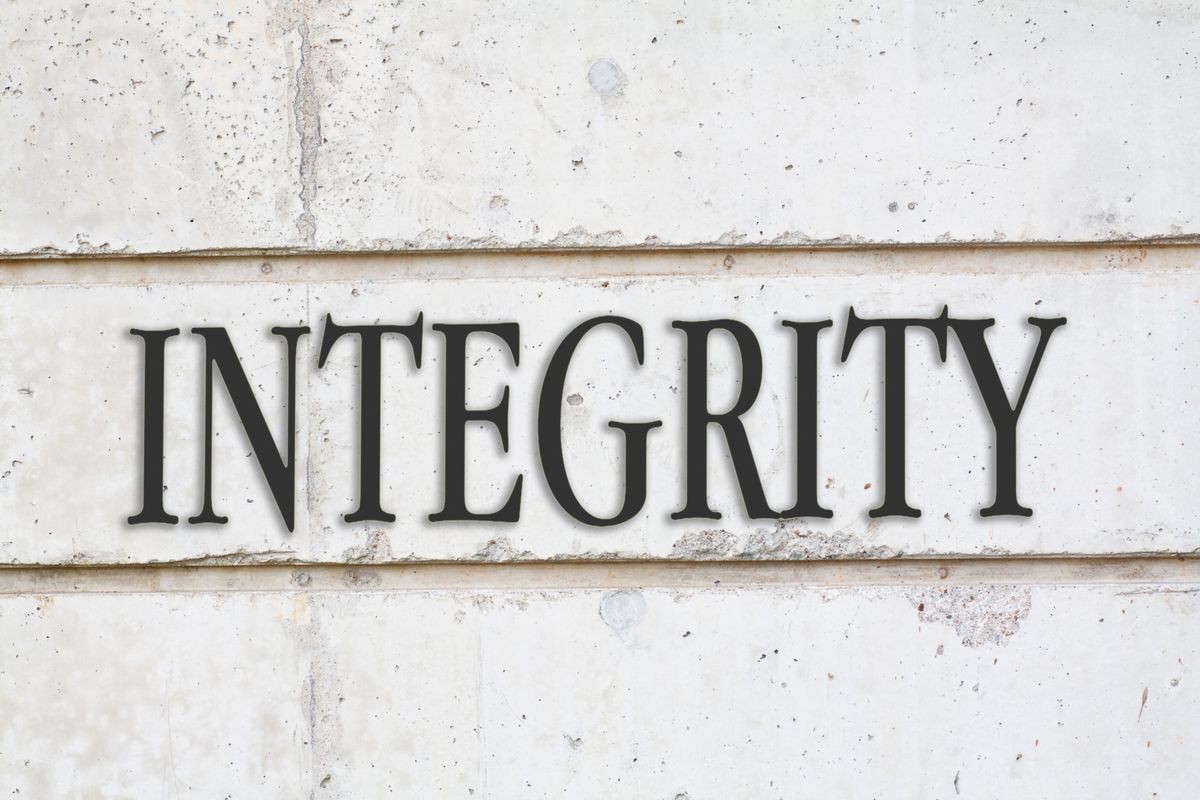 written INTEGRITY word on concrete wall background